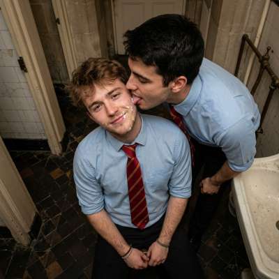 One student’s face is glazed in cum, another kneels to lick him clean in the academy’s hallowed halls #toilet #kiss...