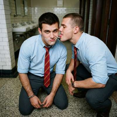 One student’s face is painted with cum, another kneels to lick him clean in the academy’s bathroom. Pure devotion. #toilet...