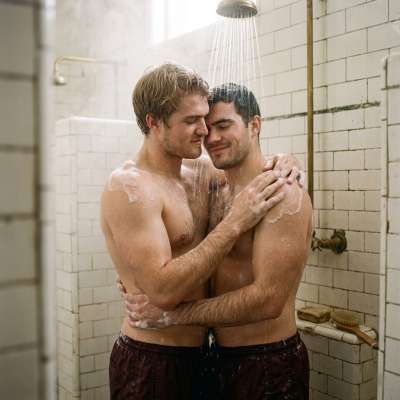 In the heart of the prestigious academy, two students share a passionate kiss under the cascading water of the shower, their...