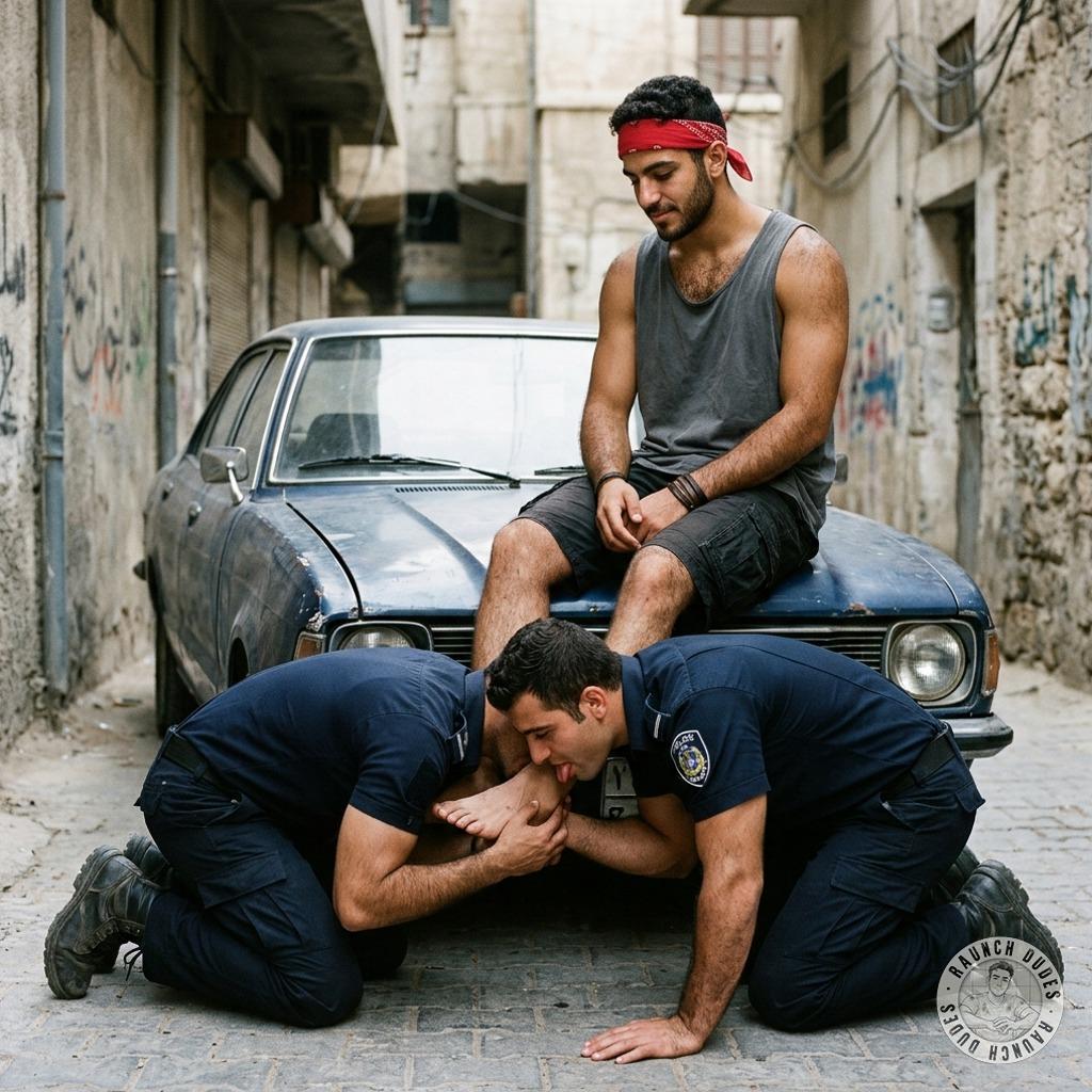 Two cops on their knees worshipping a dude’s feet, tongues sliding between each toe while he grins down at them #fetish...