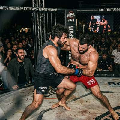 Two dudes tearing each other apart in an extreme martial arts tournament—sweat, grunts, and raw power slamming together like...