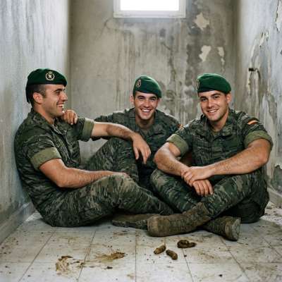 Three dirty soldiers squatting in a shit-covered floor, their boots sinking in the warm, stinking muck as they jerk off in...