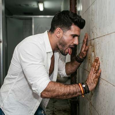 That filthy slut can’t resist licking the grimy public toilet wall, savoring every rancid drop of piss and cum dried in the...