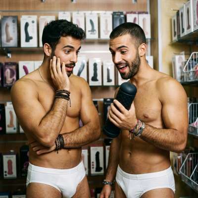 Two hungry twinks stare at a monstrous dildo in the shop, licking their lips like it’s the last meal they’ll ever eat 😈🔥...