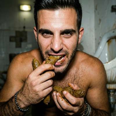 This dude’s on his knees in a filthy public bathroom, shoveling that warm, musky shit straight into his mouth like it’s the...