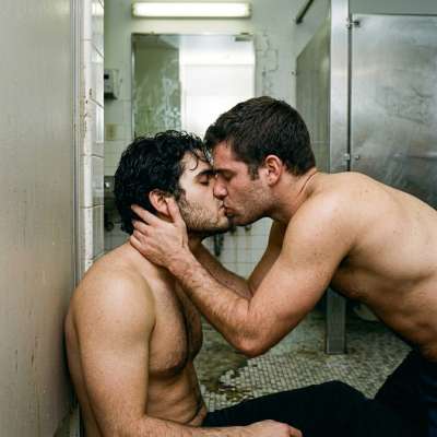 Two hot guys locked in a steamy bathroom kiss—wet lips, hard bodies, and that filthy mirror reflection. Who’s getting bent...