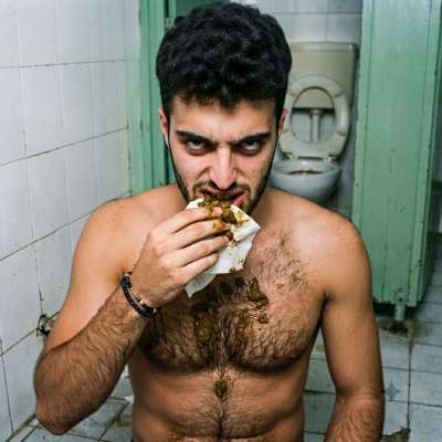 Hot as hell watching this guy devour that filthy load in a public restroom—chest hair on display, no shame, just raw hunger....