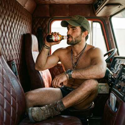 Trucker vibes never looked this hot. That grip on the beer bottle? Pure masculine energy. 🚛🍻 #worker