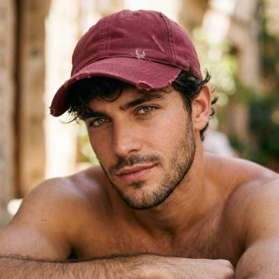 Red hat, bold gaze, confidence oozing—this man is pure magnetism. Every angle is a masterpiece. #malebeauty #nature
