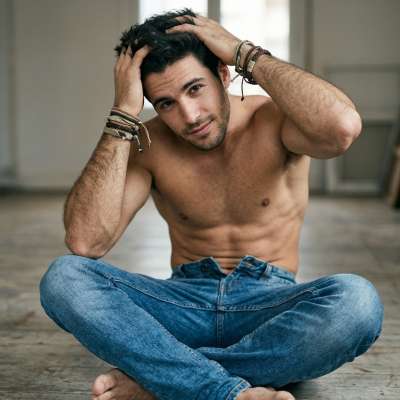 Elegance meets raw beauty as he sits effortlessly on the floor, a masterpiece of masculinity in every curve. Every angle is...