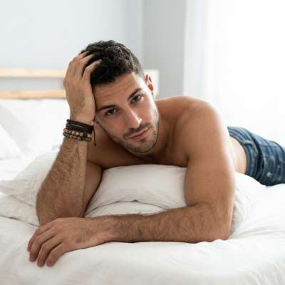 Laying back with effortless charm—pure, masculine beauty at its finest. 💙 #malebeauty #bedroom