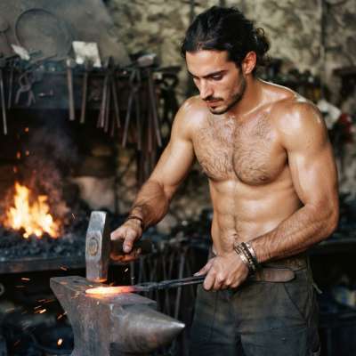 Mastering the art of fire and strength—raw beauty in every hammered stroke. #malebeauty #garage #hairy